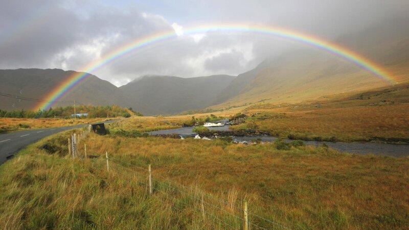 Rainbow over a mountain valley