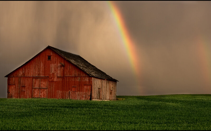 Rainbow over a red barn