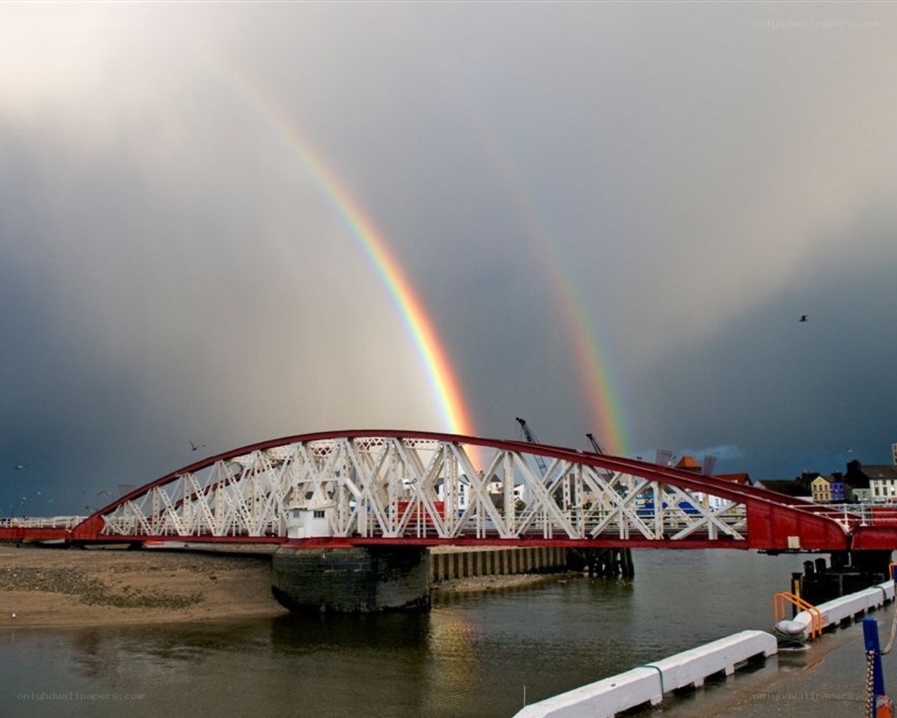 Rainbow over a red bridge