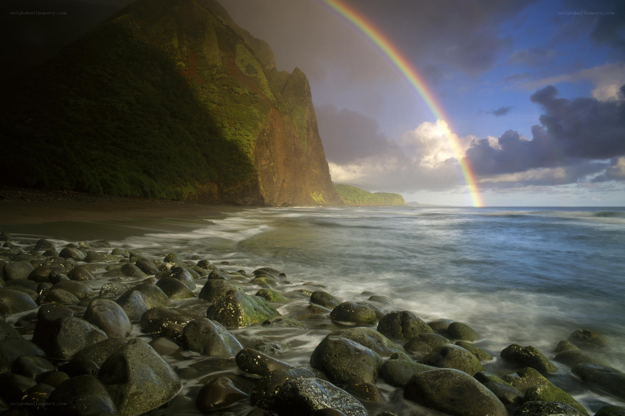 Rainbow over a rocky beach