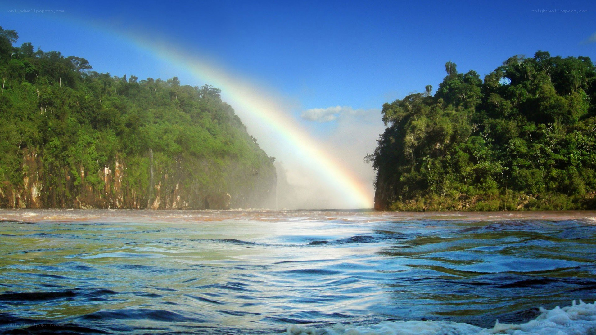 Rainbow over a tropical waterfall