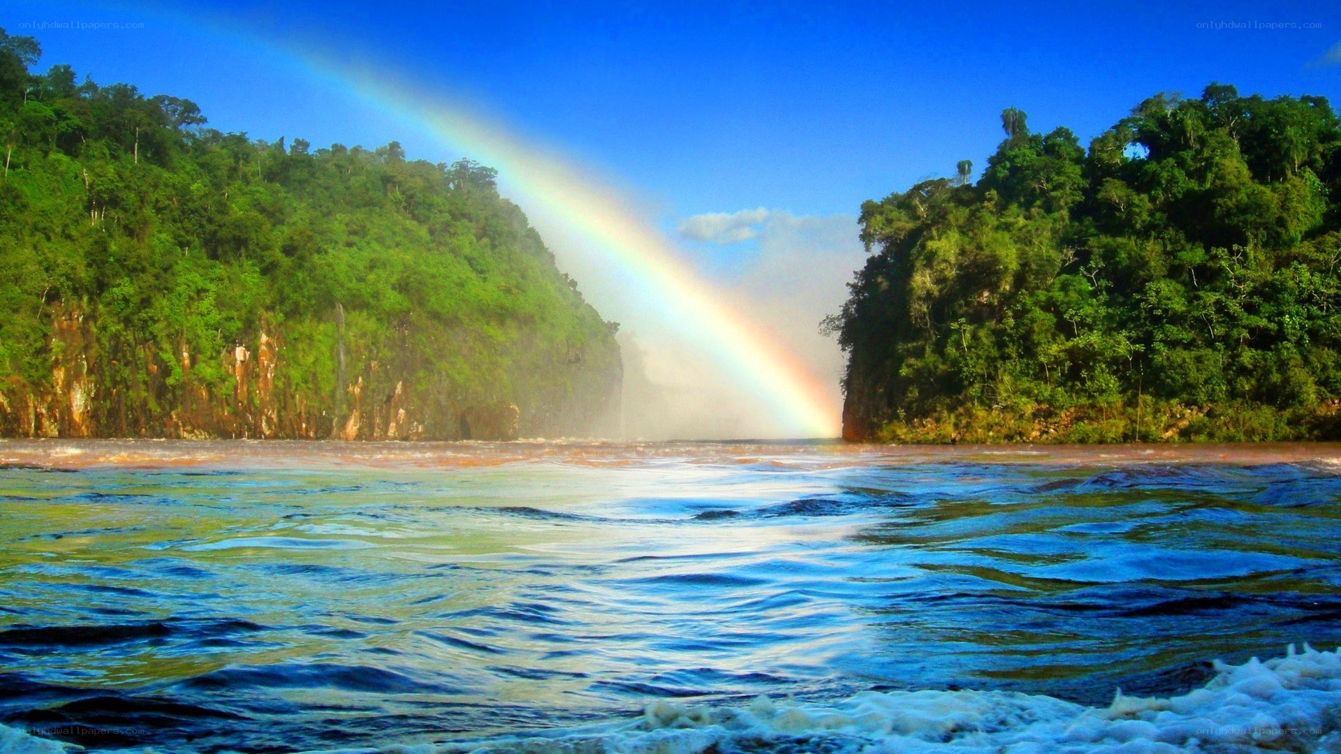 Rainbow over a tropical waterfall