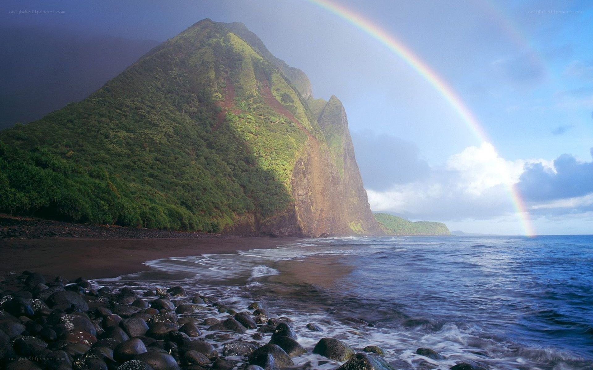 Rainbow over a volcanic coastline