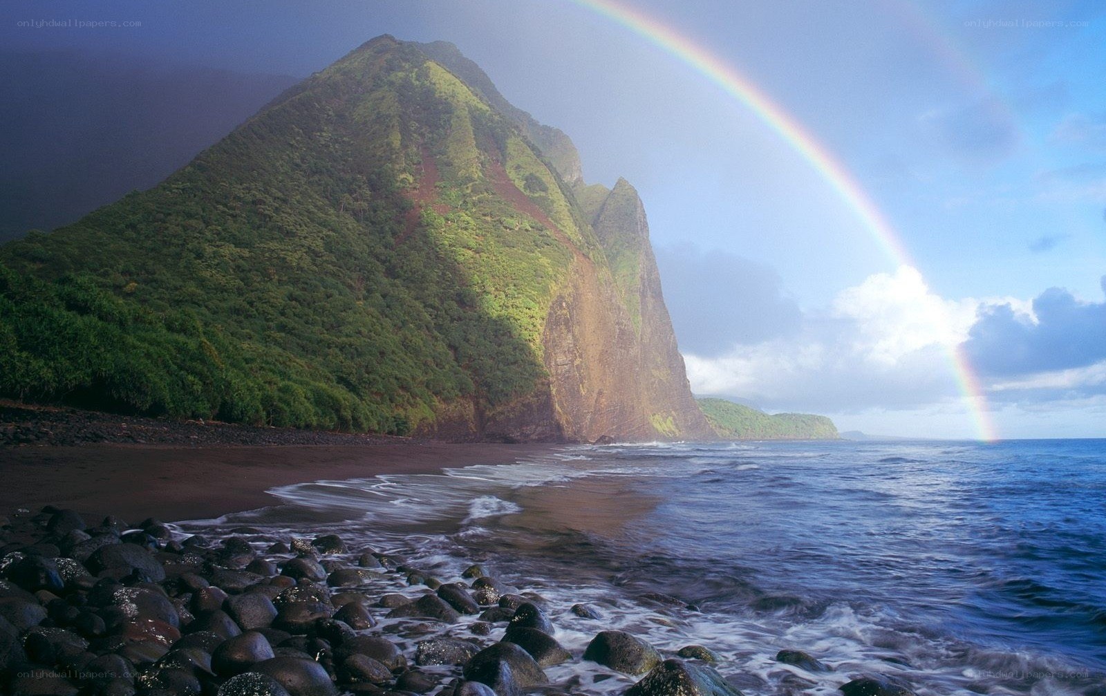 Rainbow over a volcanic island