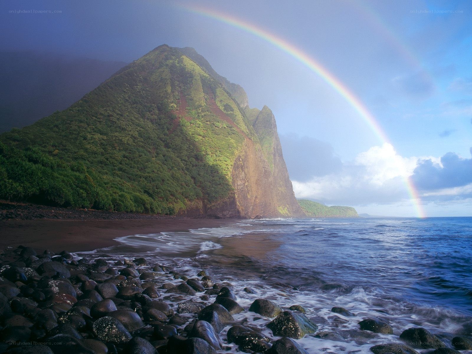 Rainbow over a volcanic island