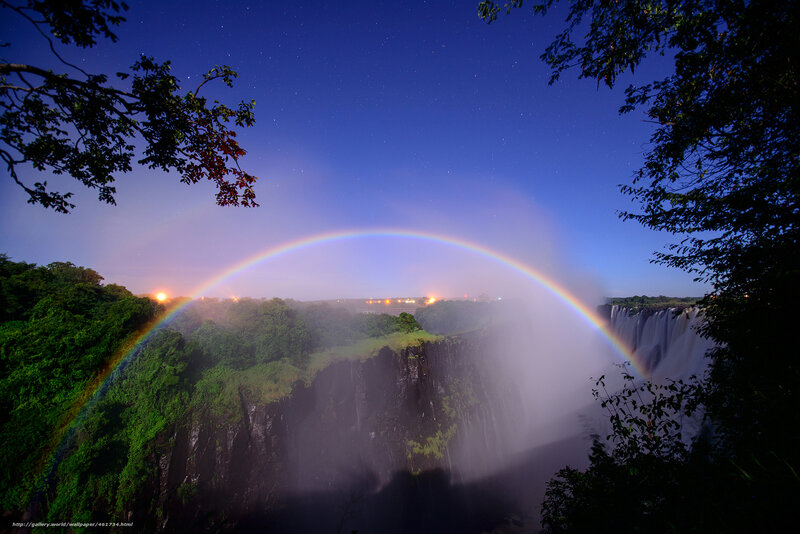 Rainbow over a waterfall at night