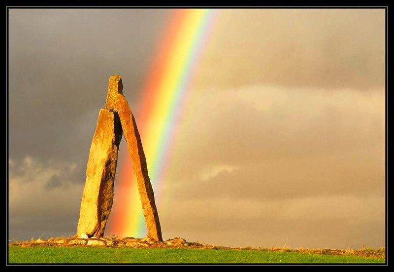 Rainbow over ancient stone monument