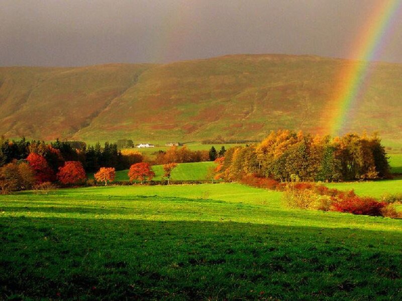 Rainbow over autumn hills