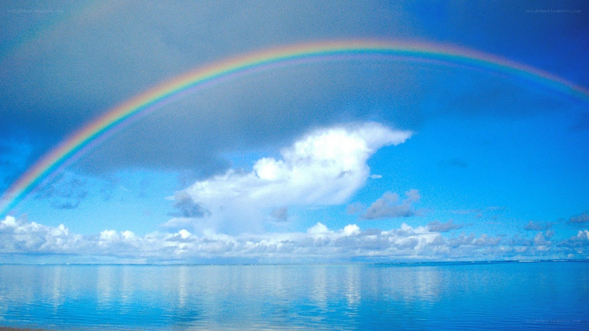 Rainbow over calm ocean