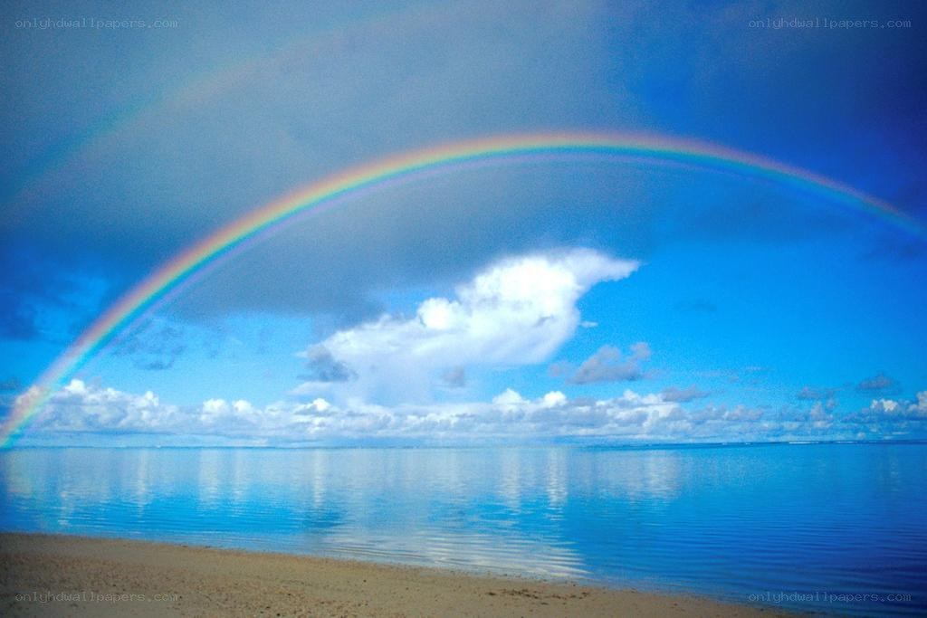 Rainbow over calm ocean