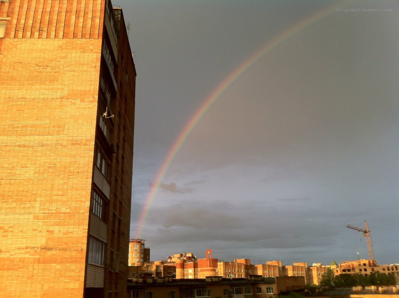 Rainbow over city buildings