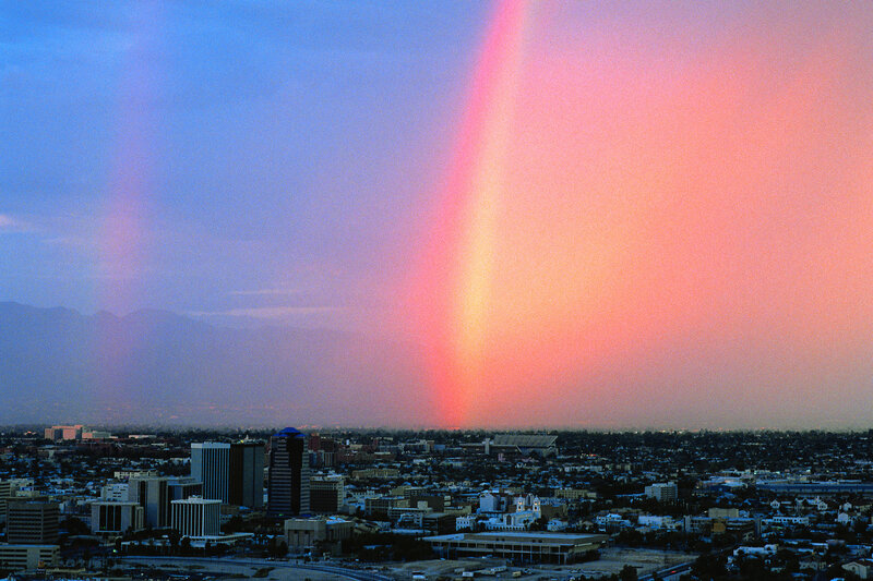 Rainbow over city skyline