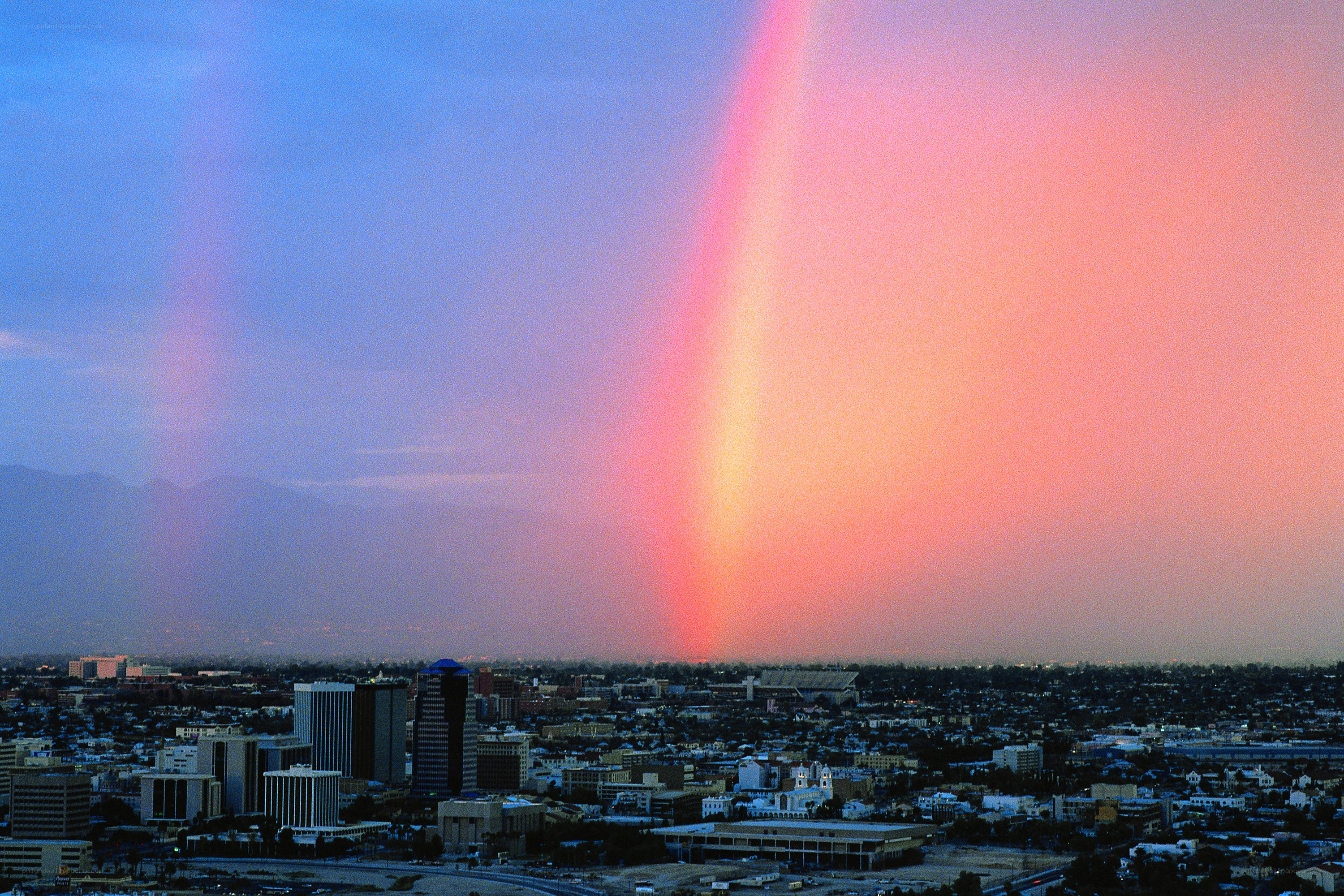Rainbow over city skyline