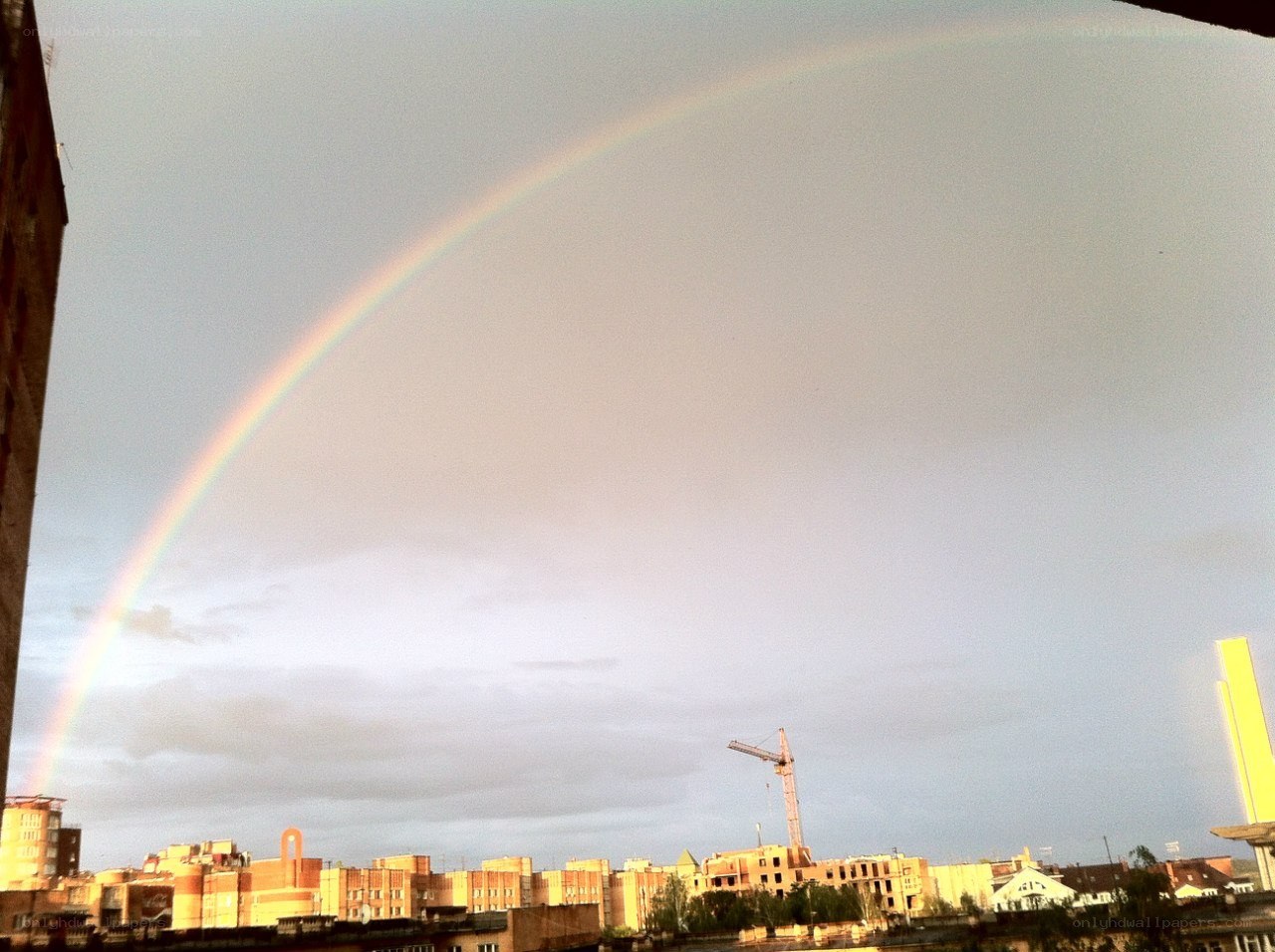 Rainbow over city skyline