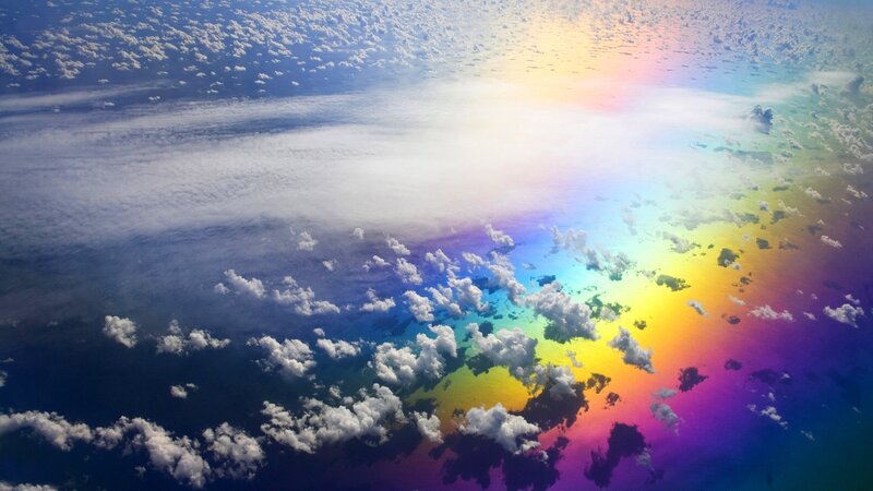 Rainbow over clouds from above