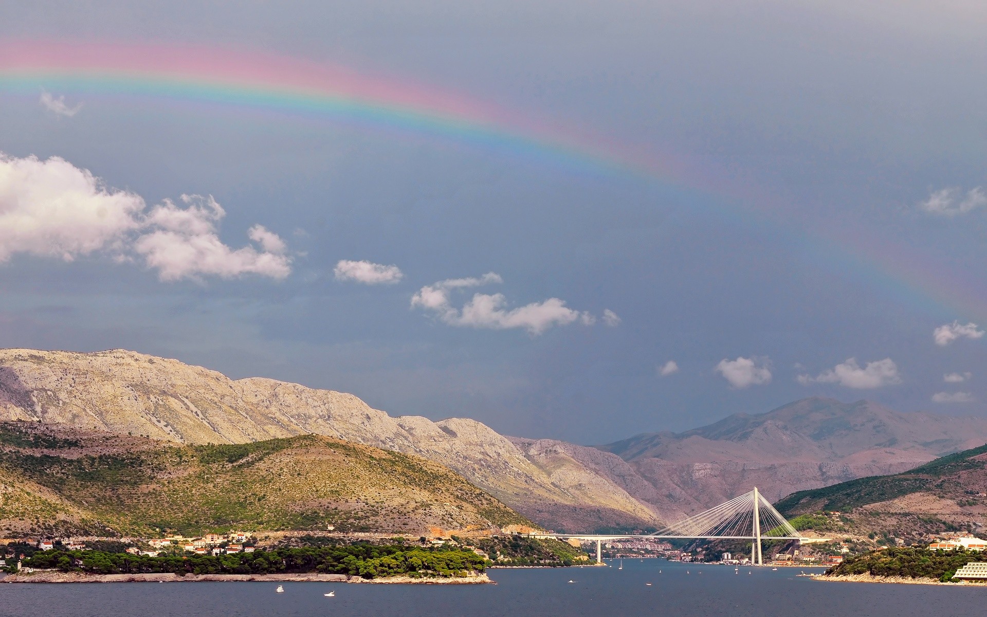 Rainbow over coastal bridge