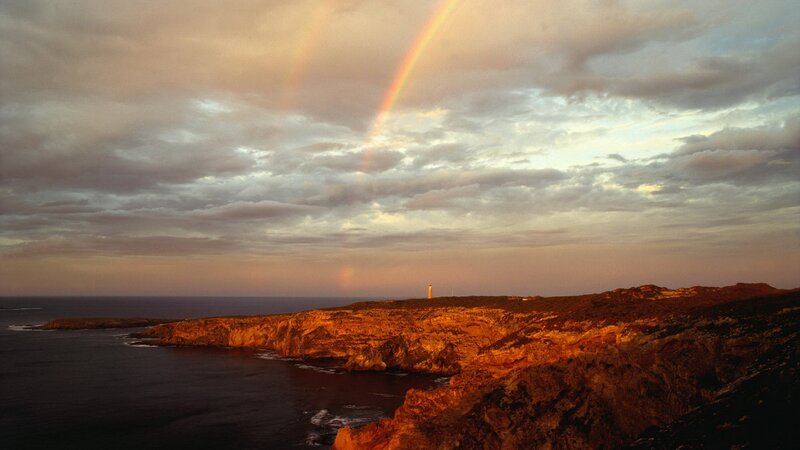 Rainbow over coastal cliffs