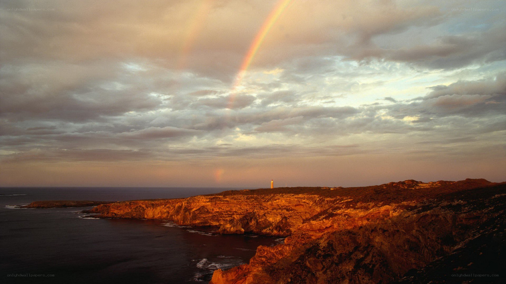 Rainbow over coastal cliffs