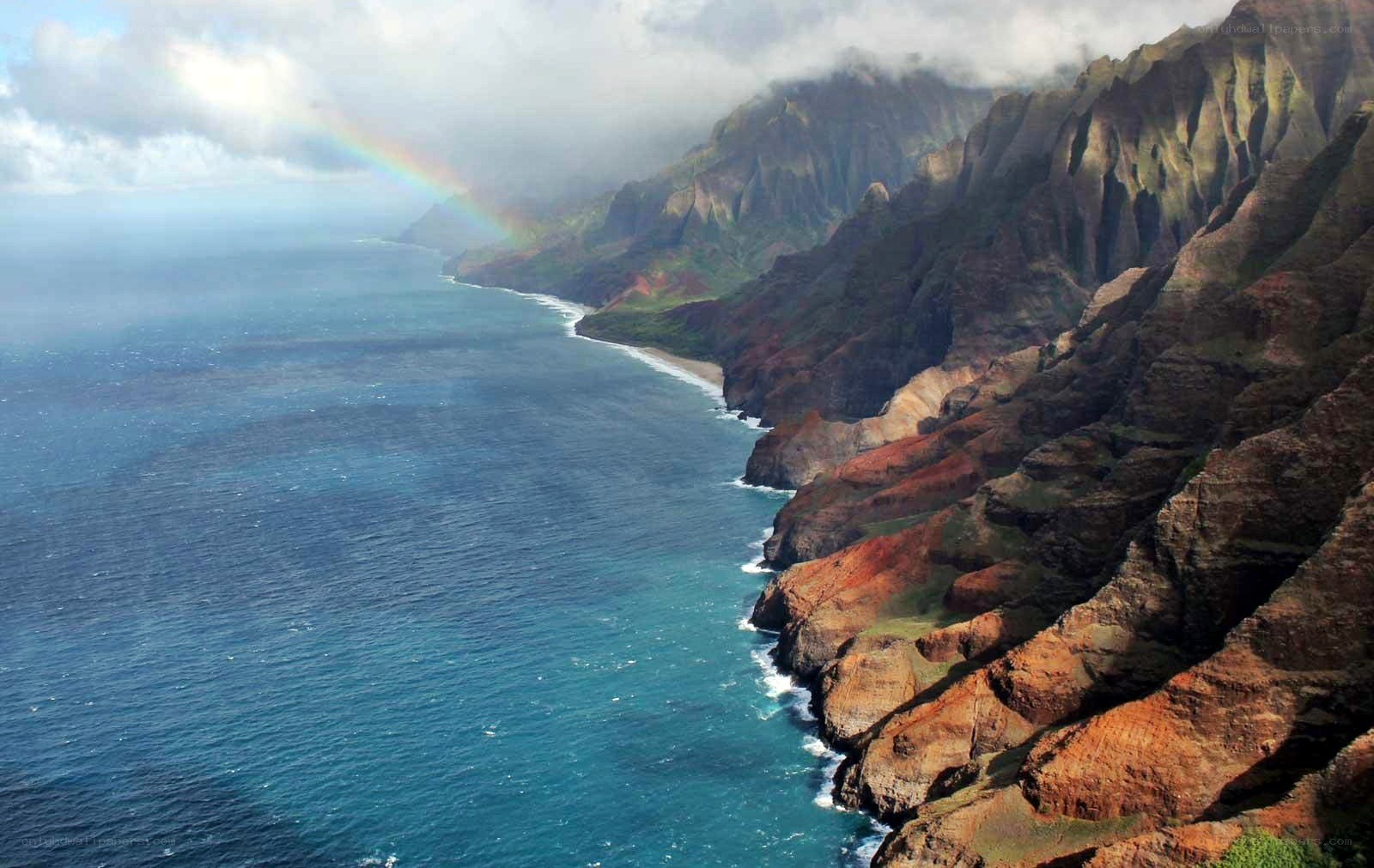 rainbow over coastal cliffs