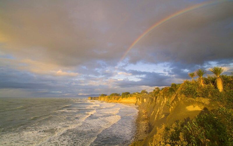 Rainbow over coastal cliffs