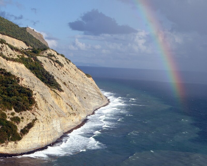 Rainbow over coastal cliffs