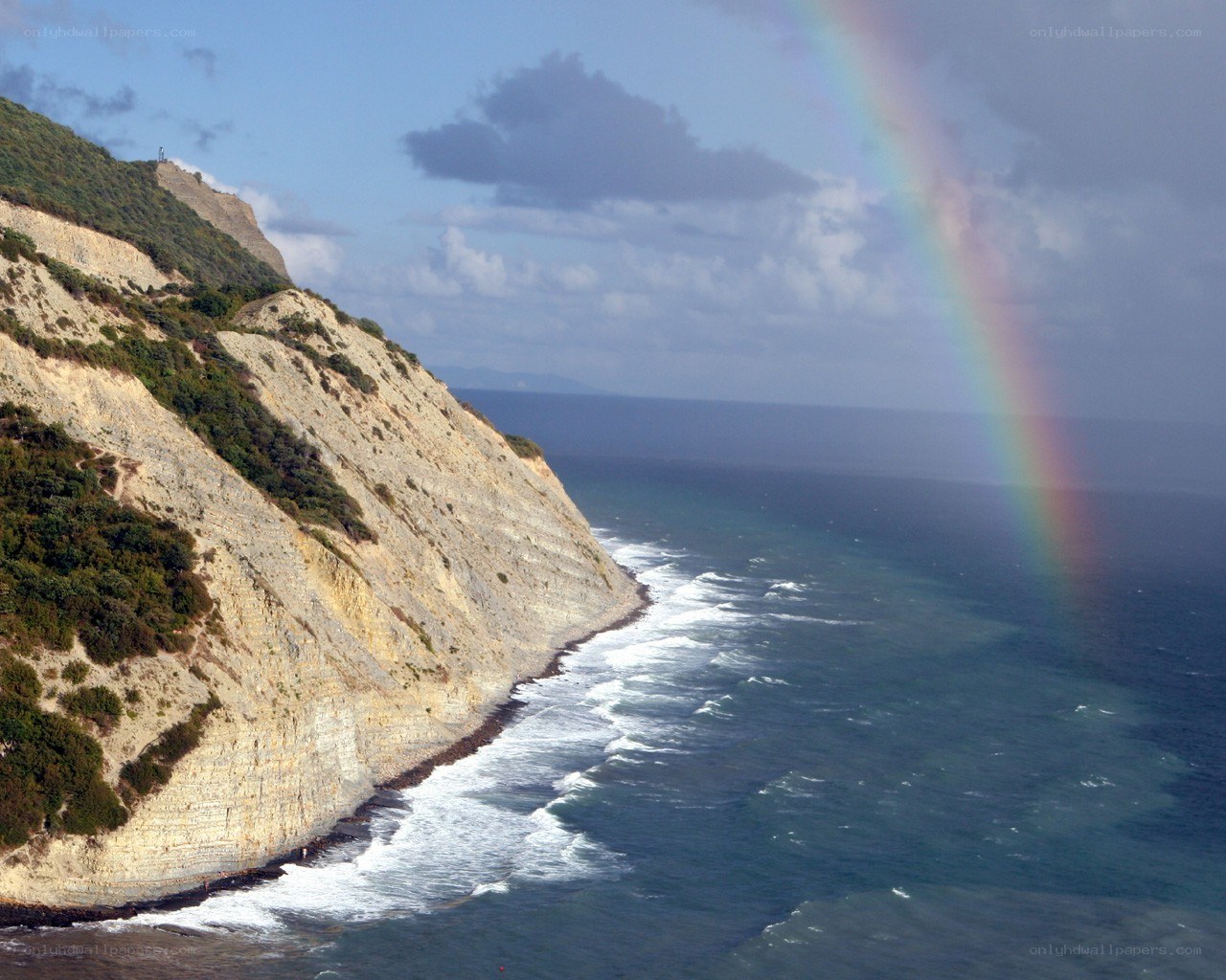 Rainbow over coastal cliffs