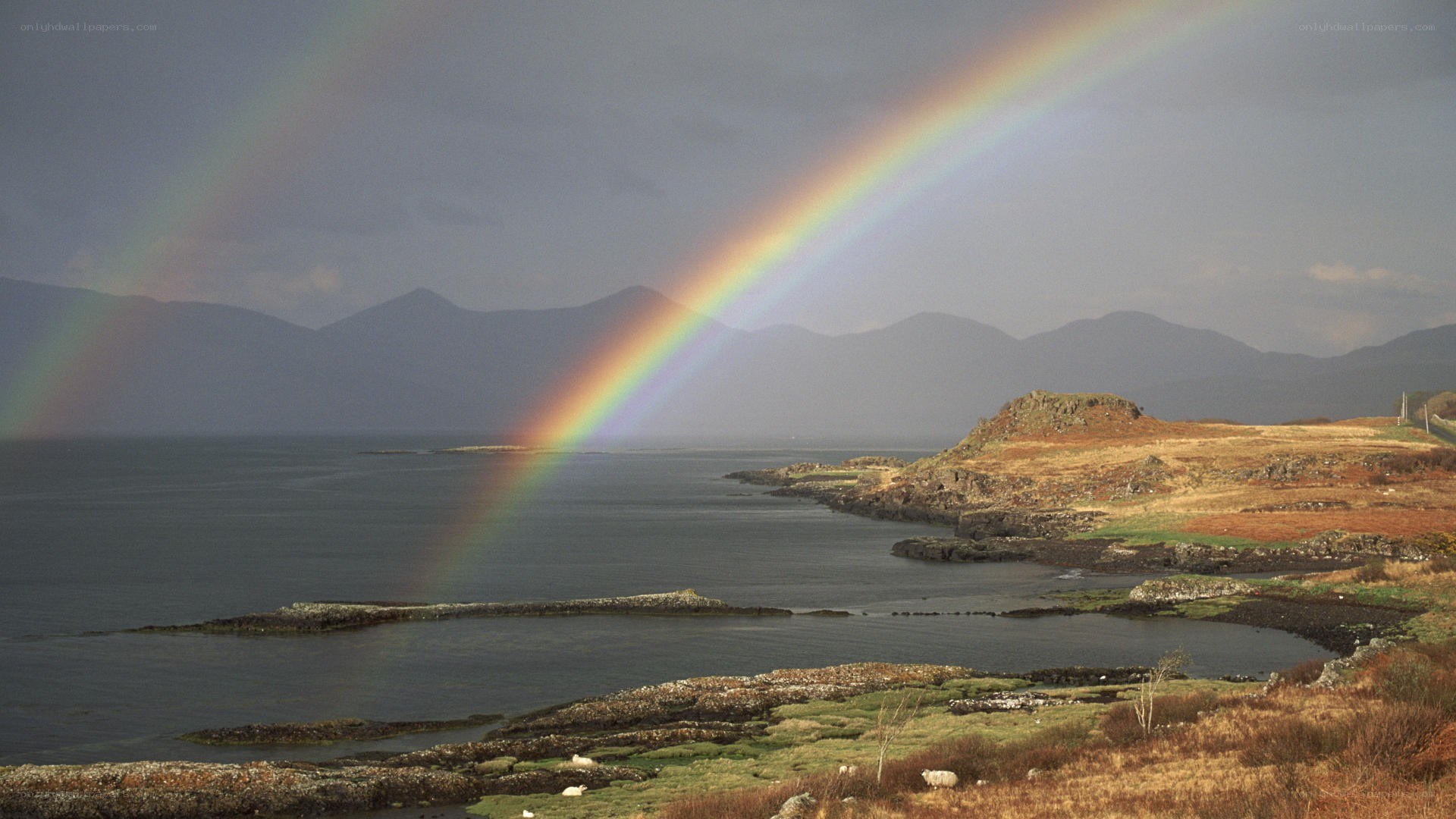 Rainbow over coastal hills