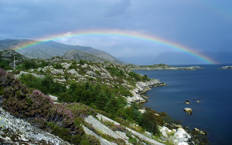 Rainbow over coastal hills