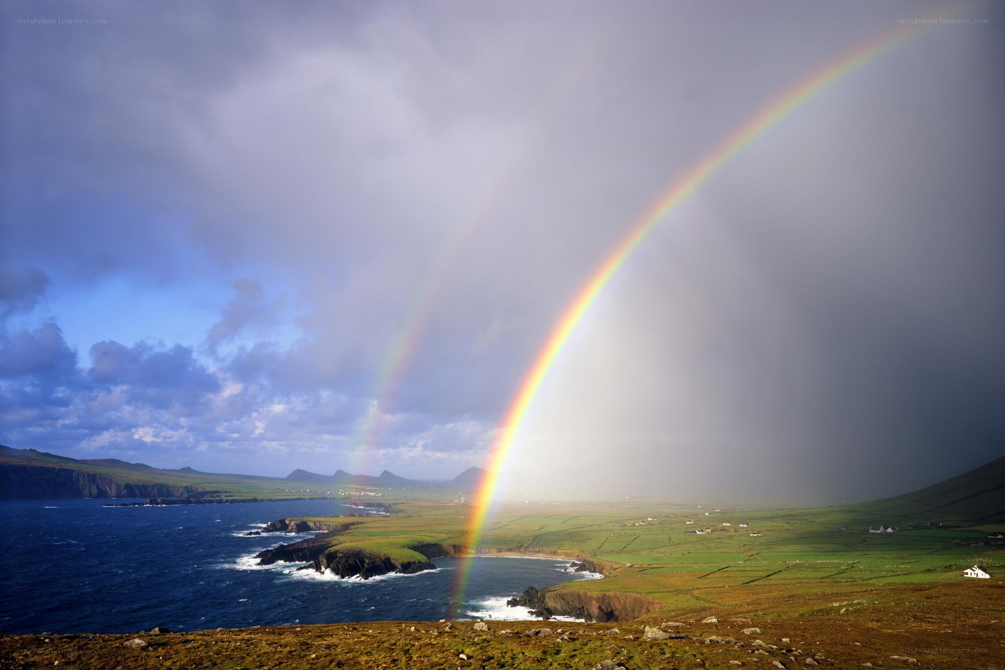 Rainbow over coastal landscape