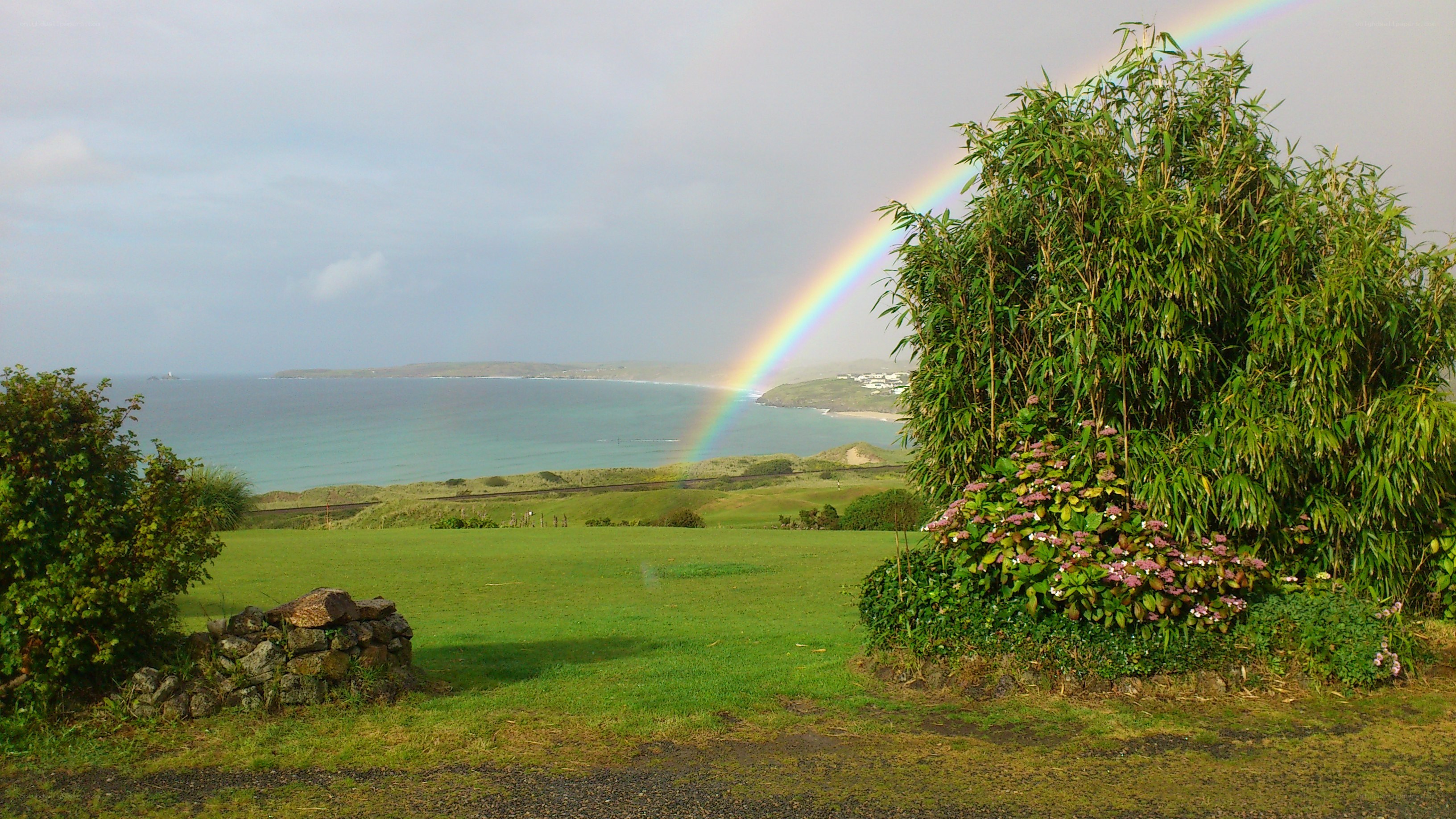 Rainbow over coastal landscape