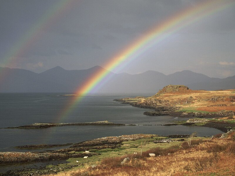 Rainbow over coastal landscape