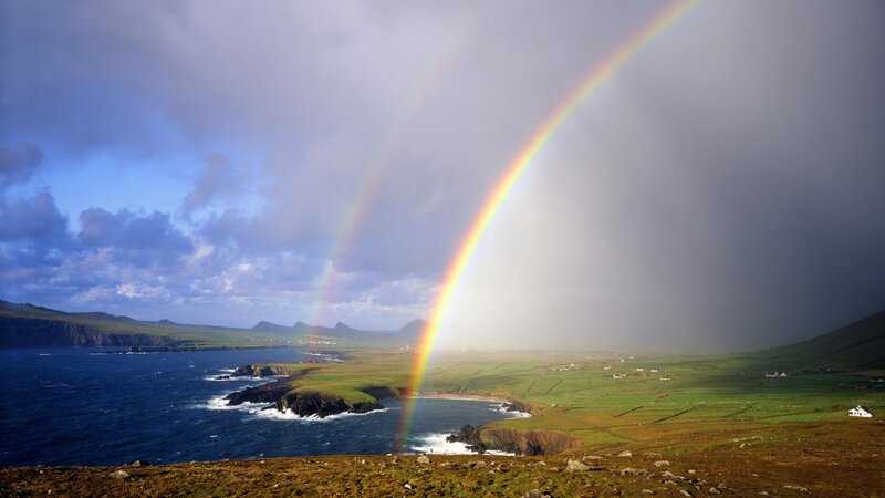 Rainbow over coastal landscape