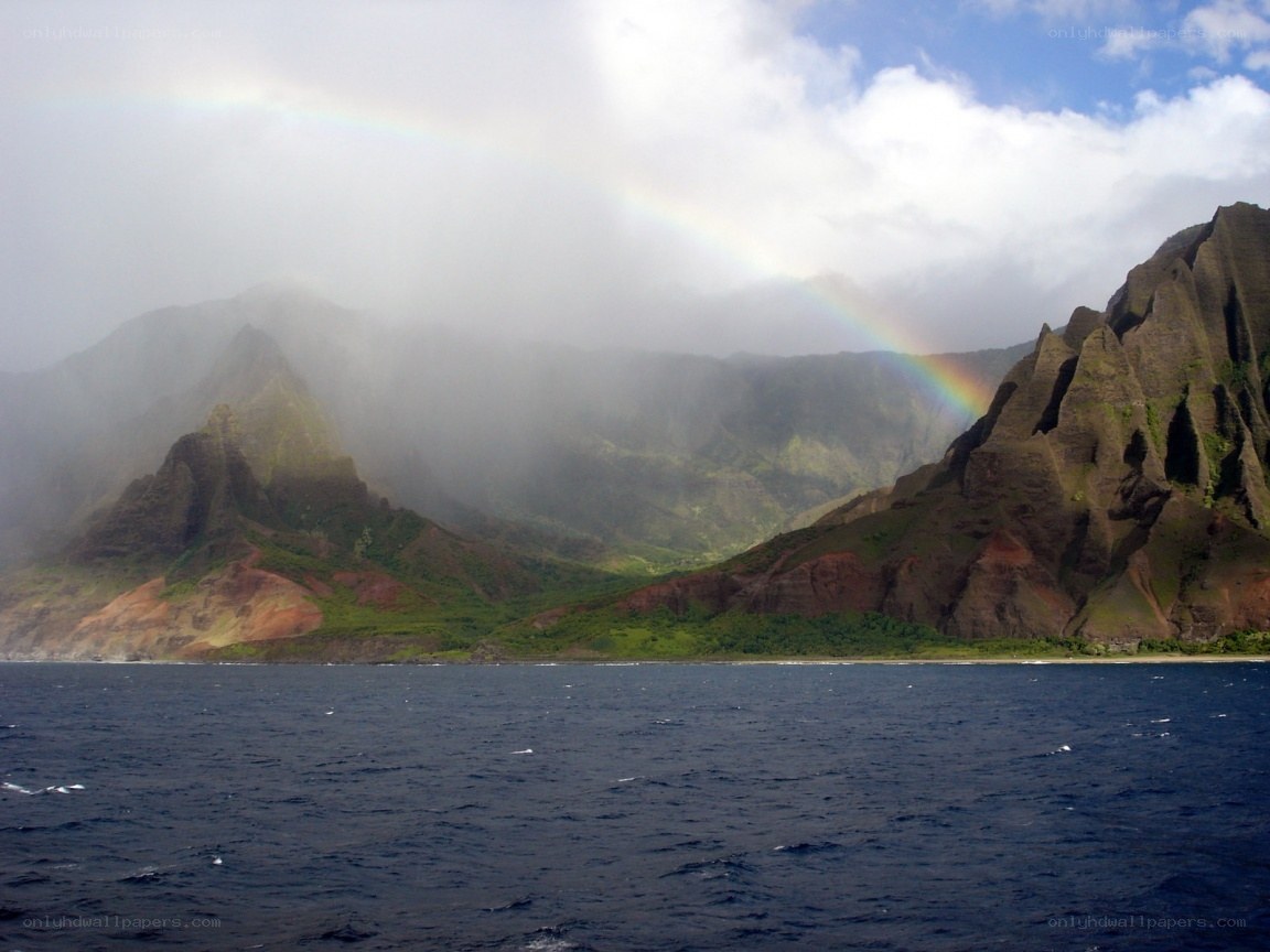 rainbow over coastal mountains