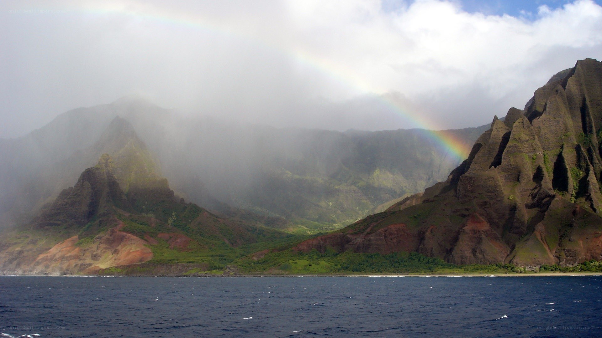 rainbow over coastal mountains