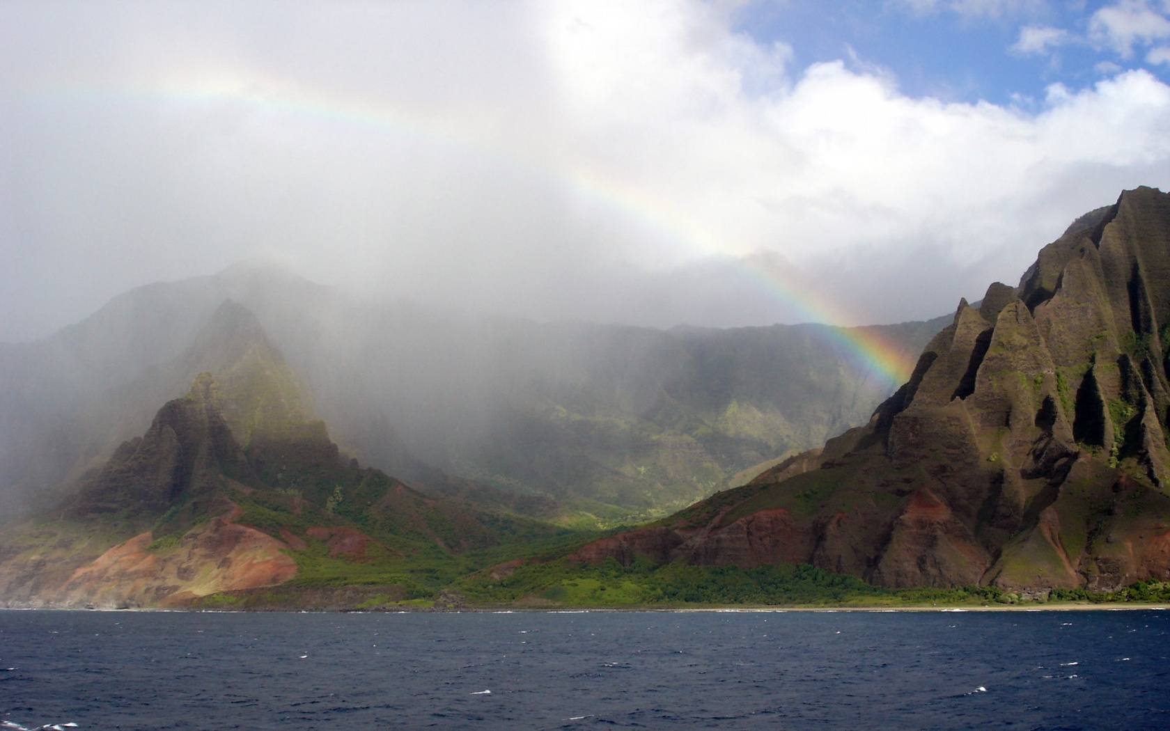 rainbow over coastal mountains