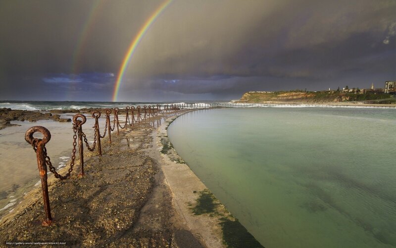 Rainbow over coastal pool