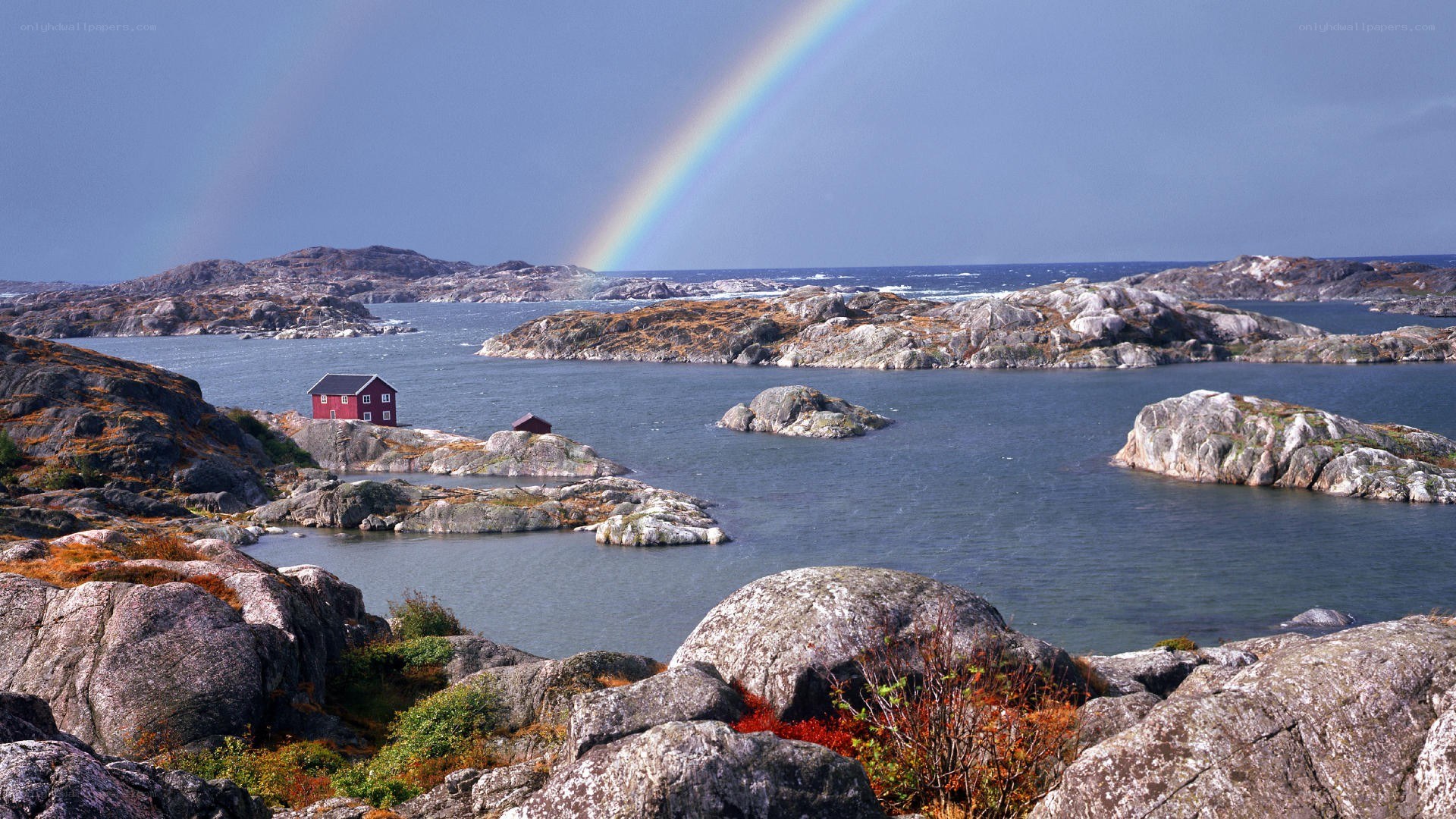 Rainbow over coastal rocks