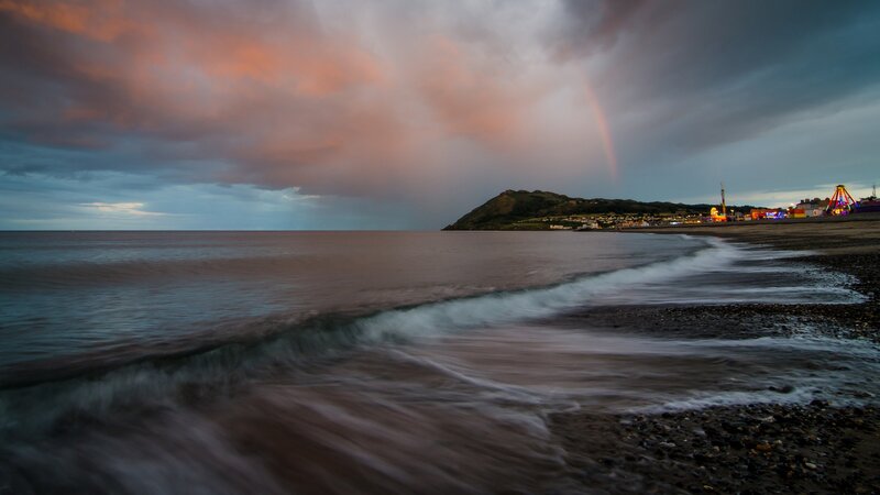 rainbow over coastal town