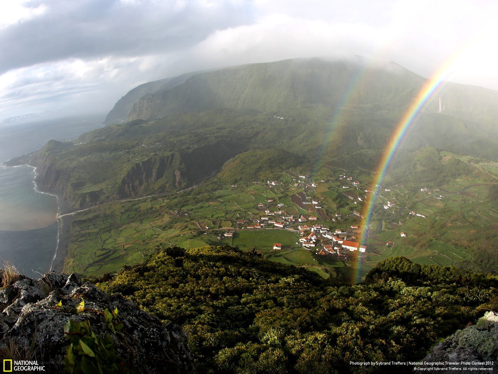 Rainbow over coastal village