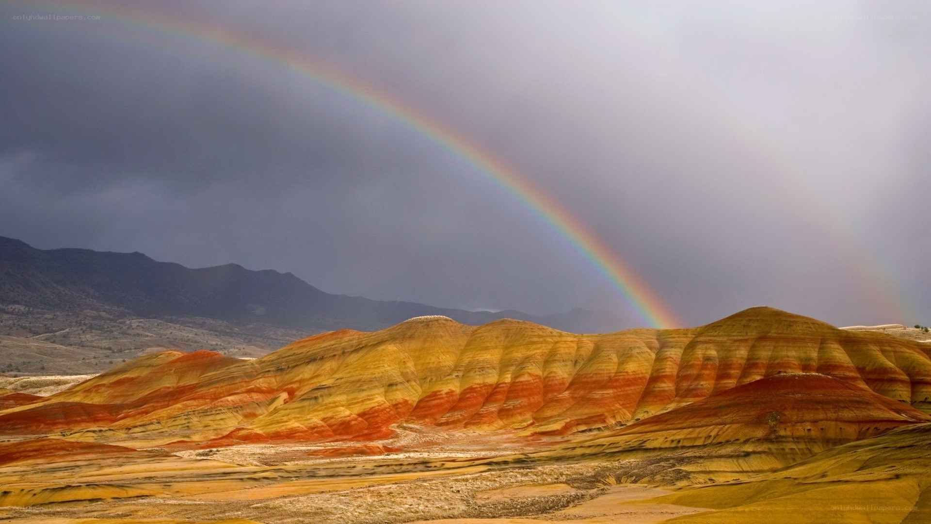 Rainbow over colorful hills