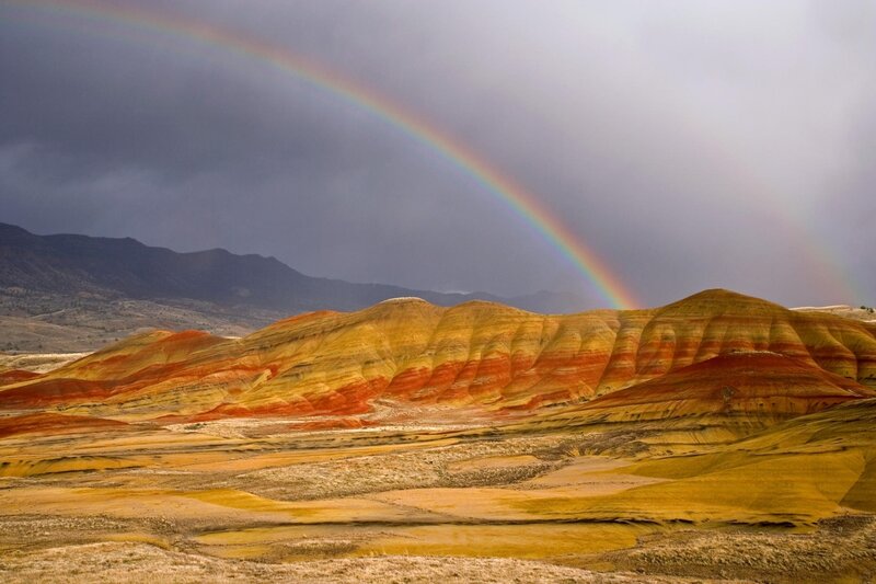 Rainbow over colorful hills
