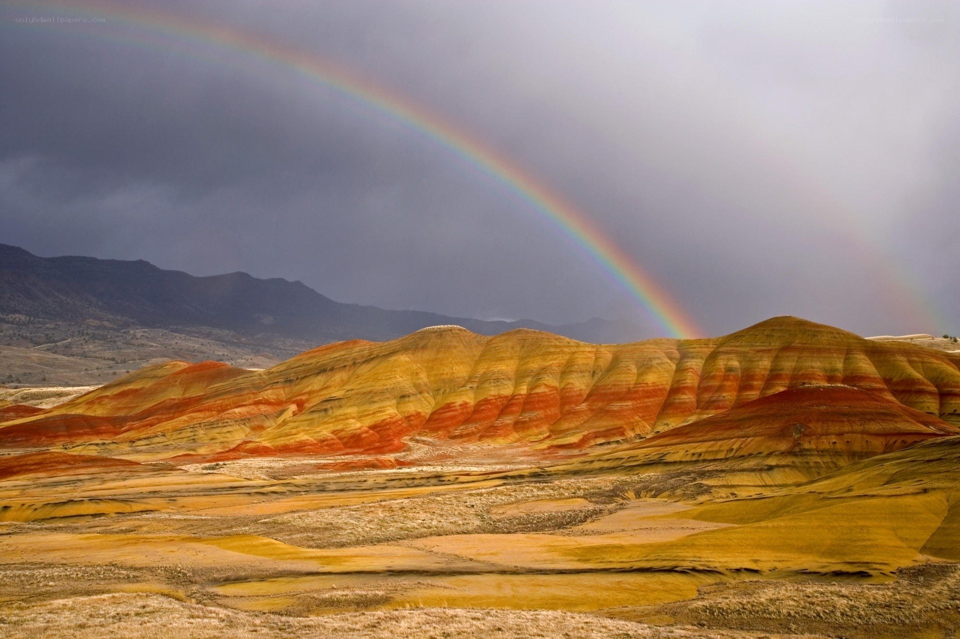 Rainbow over colorful hills