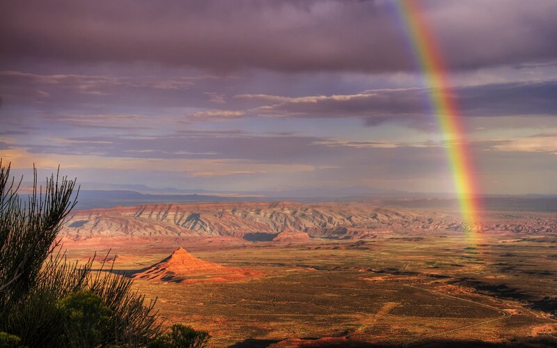 Rainbow over desert canyon
