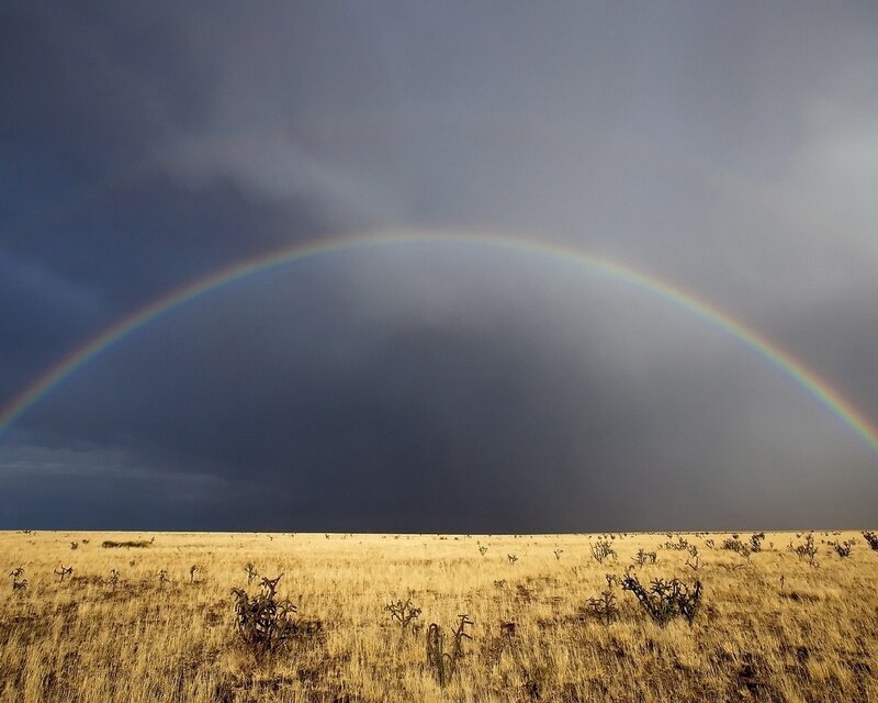 Rainbow over desert landscape