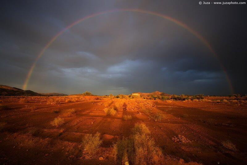 Rainbow over desert landscape