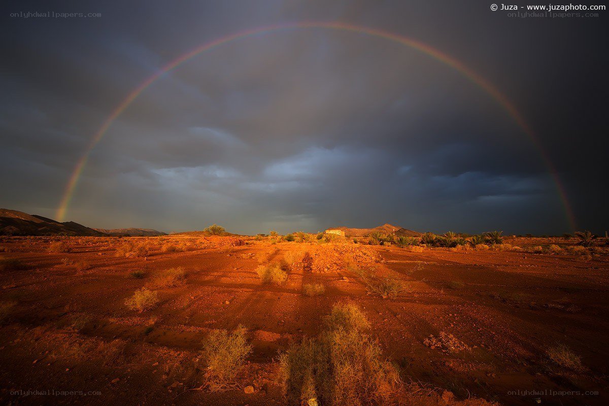 Rainbow over desert landscape