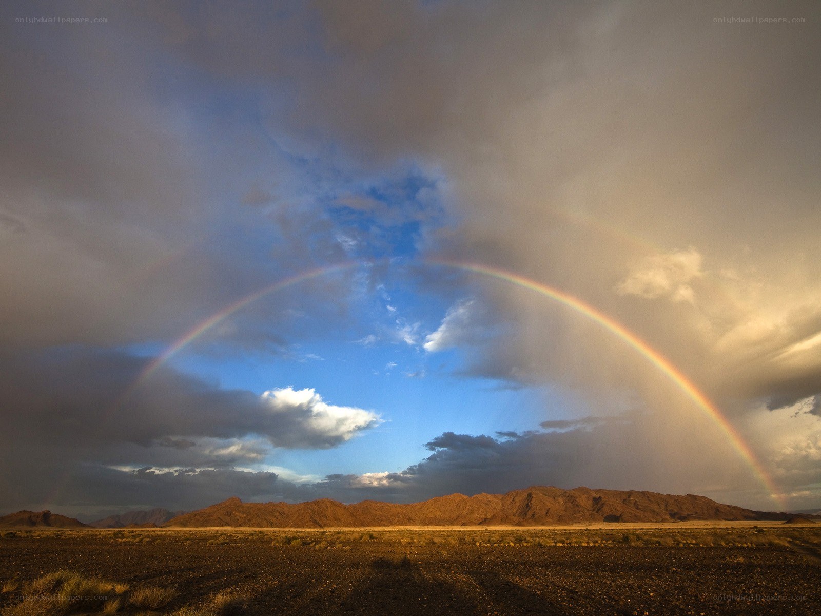 Rainbow over desert mountains
