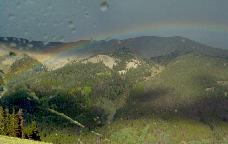 Rainbow over Forested Mountains