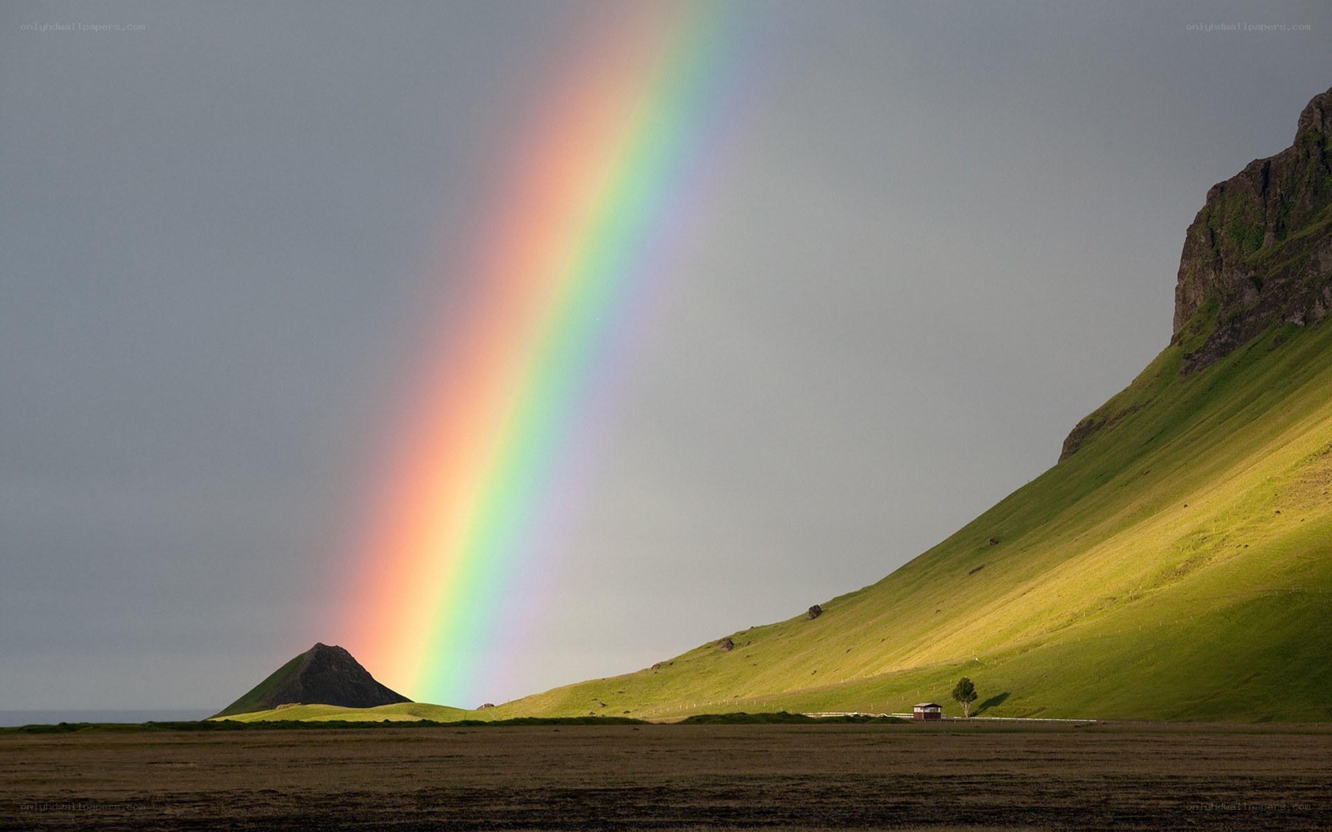 Rainbow over green hills