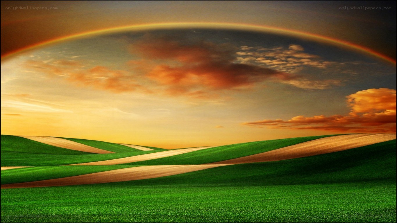Rainbow over green hills